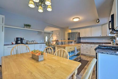 a large kitchen with a wooden table and chairs at Spacious Home Near Bromley Mountain Ski Resort! in Manchester Center