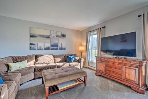 a living room with a couch and a flat screen tv at Spacious Home Near Bromley Mountain Ski Resort! in Manchester Center