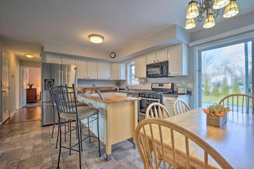 a kitchen with a table and chairs and a counter at Spacious Home Near Bromley Mountain Ski Resort! in Manchester Center