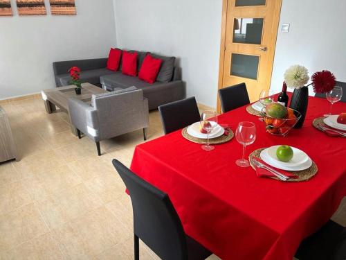 a living room with a table with a red table cloth at Calle Mora De Rubielos with Free Private Underground Parking in Valencia