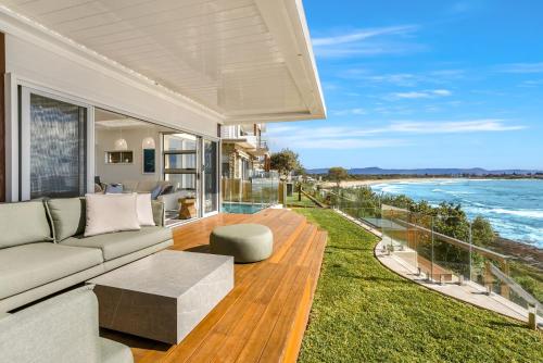 a living room with a couch and a view of the ocean at Surf Beach House in Shellharbour