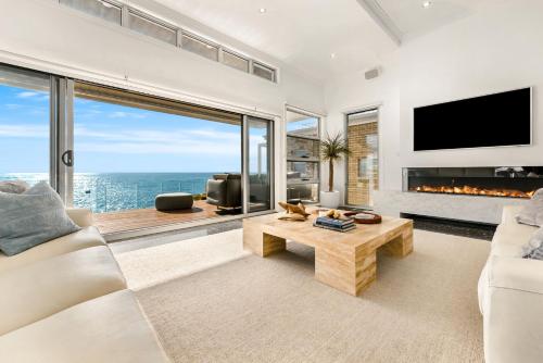 a living room with a view of the ocean at Surf Beach House in Shellharbour