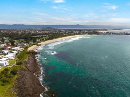 an aerial view of a beach and the ocean at Surf Beach House in Shellharbour