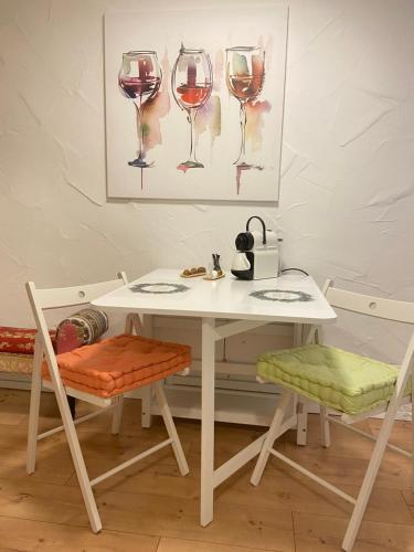 a white table and chairs with wine glasses at Apartment Balingen City in Balingen