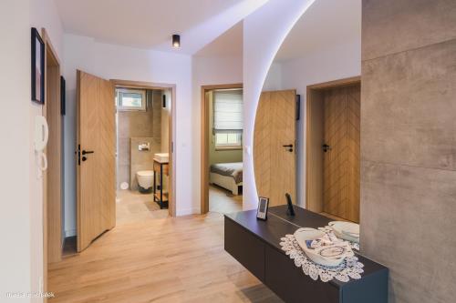 a bathroom with a sink and a mirror at DAJ SOBIE CZAS Apartament in Istebna