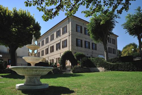 a large building with a fountain in front of a building at Hotel Bel Sit in Senigallia