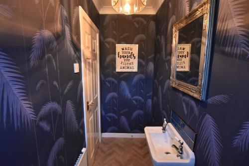 a bathroom with a sink and a mirror at The Nutshell, a Luxury mews property! in Southport