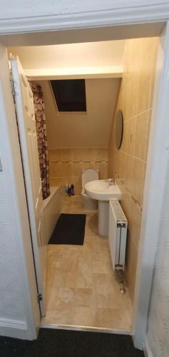 a small bathroom with a toilet and a sink at Hustlers inn apartment in Newcastle upon Tyne