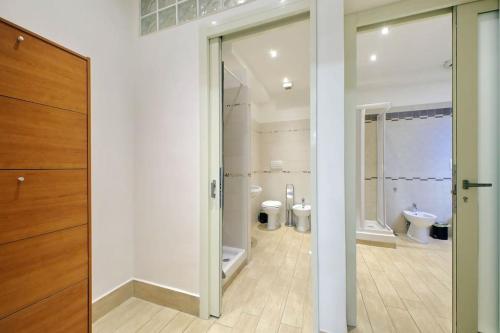 a bathroom with two toilets and a sliding glass door at Vatican Flat Spacious Cozy with Court in Rome