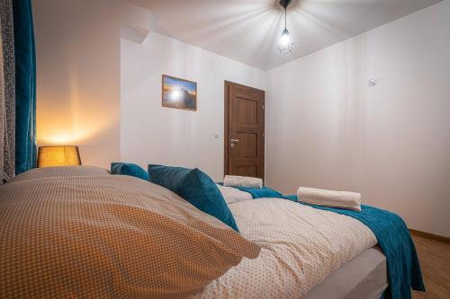 a bedroom with a bed with a blanket on it at Domki Bukowianka in Murzasichle