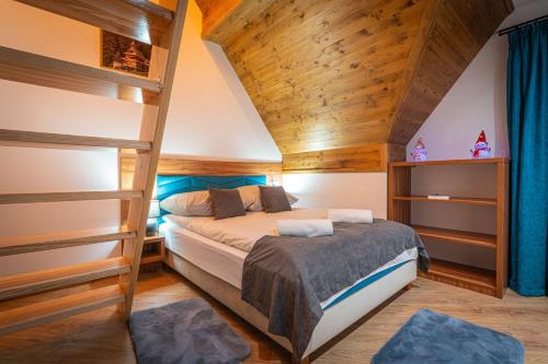 a bedroom with a bed and two bunk beds at Domki Bukowianka in Murzasichle