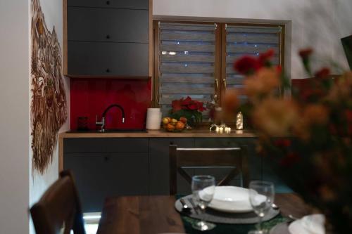 a kitchen with a table and a sink and a window at Domki Bukowianka in Murzasichle