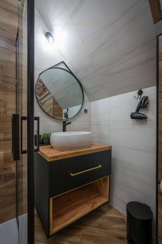 a bathroom with a sink and a mirror at Domki Bukowianka in Murzasichle