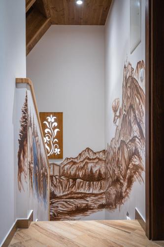 a mural of a mountain on a wall in a hallway at Domki Bukowianka in Murzasichle