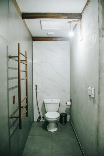 a small bathroom with a toilet in a stall at Pousada Reserva Tatuamunha in Pôrto de Pedras