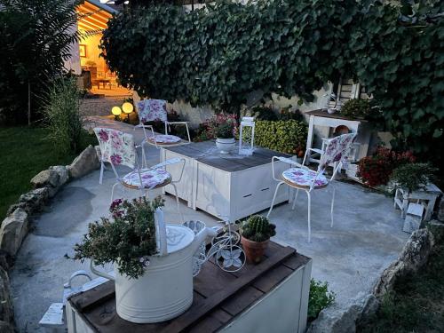 a patio with chairs and a table with plants at Bela Vila in Negotin