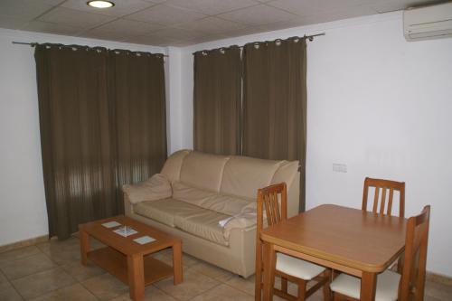 a living room with a couch and a table at Hotel Sierra Mar in La Unión