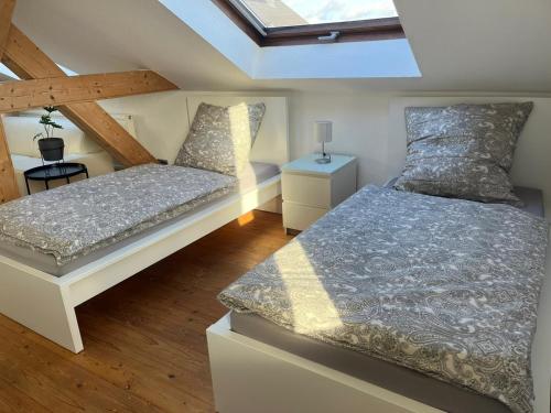 a attic bedroom with two beds and a skylight at Urlaub nicht nur für Monteure "K3" in Gera