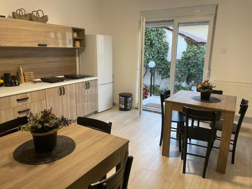 a kitchen and dining room with a table and chairs at Bela Vila in Negotin