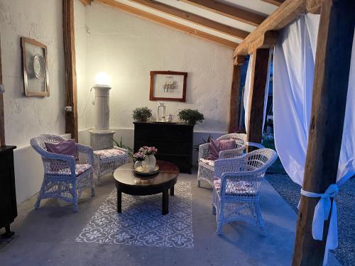 a living room with chairs and a coffee table at Bela Vila in Negotin