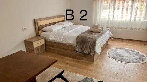 Un dormitorio con una cama y una mesa. en Dritëza, en Korçë