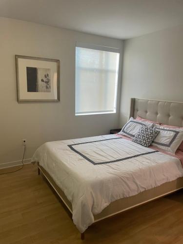 a bedroom with a large bed with a window at Super-Cute 2/2 apartment in Santa Monica with free parking in Los Angeles