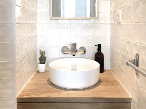 y baño con lavabo blanco y espejo. en Appartement spacieux & calme avec vue sur l'Escaut, en Tournai