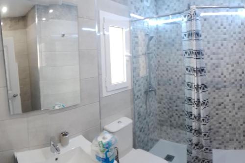 a bathroom with a shower and a toilet and a sink at Premium Duplex Castillo Mar 32 in Caleta De Fuste