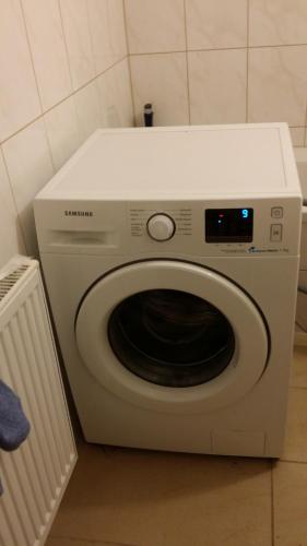 a white washing machine sitting in a room at Stellas Monteurs u. Ferienwohnung in Mülsen