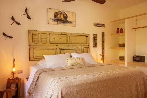 a bedroom with a large bed with white pillows at El Corazón Boutique Hotel - Adults Only with Beach Club pass included in Holbox Island
