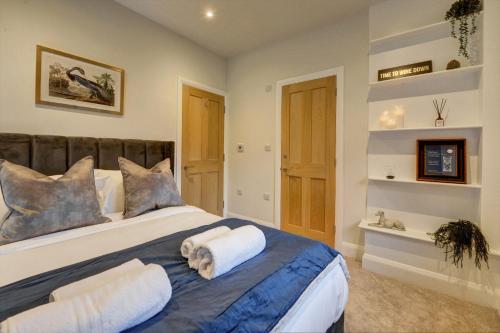 a bedroom with a large bed with two pillows at The Penthouse - Allocated Parking with City Views in Ripon