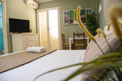 a bedroom with a bed with a towel on it at House Orlando in Sferracavallo