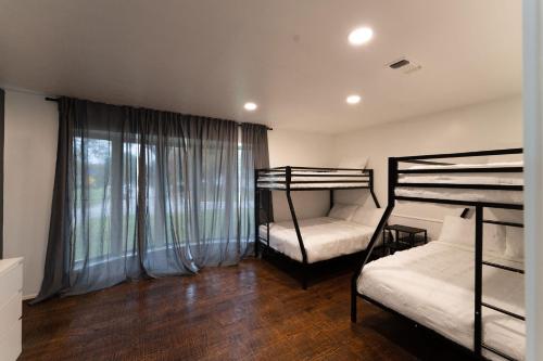 a bedroom with two bunk beds and a window at The Magnolia House- One of a kind home in the city in Arlington