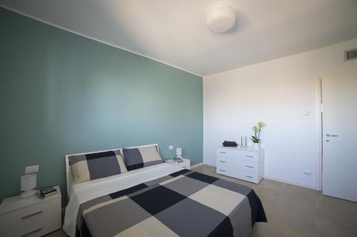 a bedroom with a black and white bed and a dresser at Residence Milano Bicocca in Milan