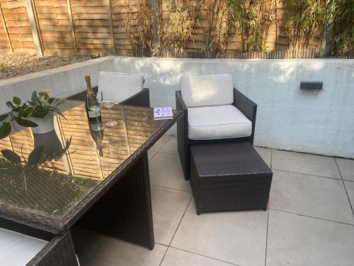 a glass table and a chair on a patio at The Flamingo in London