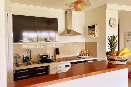 a kitchen with a sink and a counter top at Sunset Lodge SXM - T2, cosy, piscine, vue lagon & bons plans in Marigot