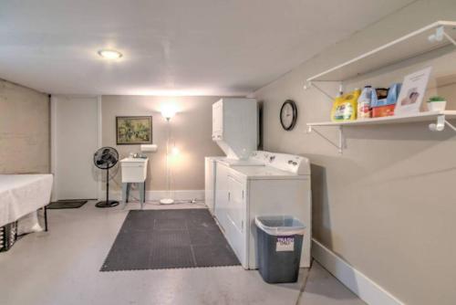 a room with a kitchen with a sink and a refrigerator at Urban Zen Great Location in Memphis