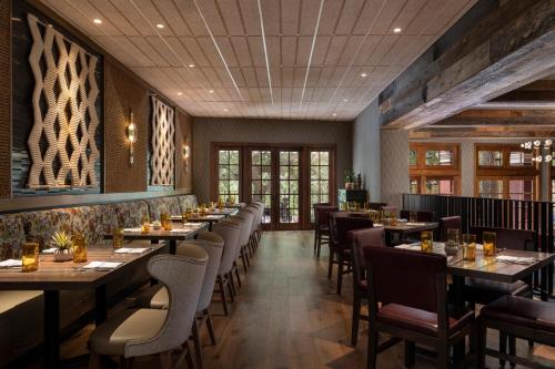 a restaurant with tables and chairs in a room at Omni La Mansion del Rio in San Antonio