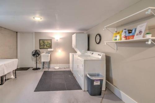a room with a kitchen with a sink and a refrigerator at Splendid Colonial in Midtown with Parking in Memphis