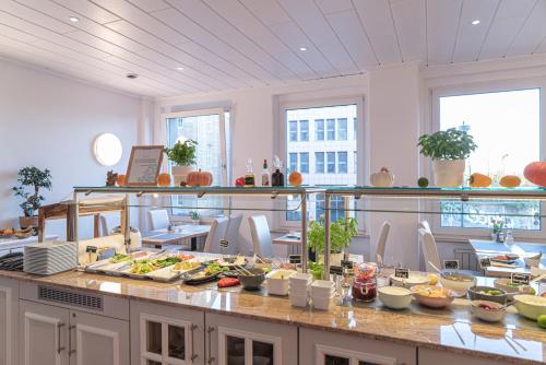 a kitchen with a buffet of food on a counter at NP Hotel Königshof in Dortmund
