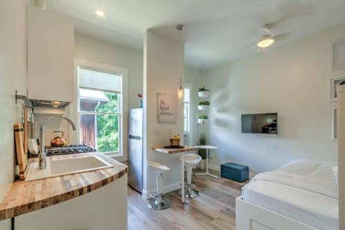 a kitchen with a sink and a counter top at Miraculously Modern in a Vintage Shell Midtown in Memphis