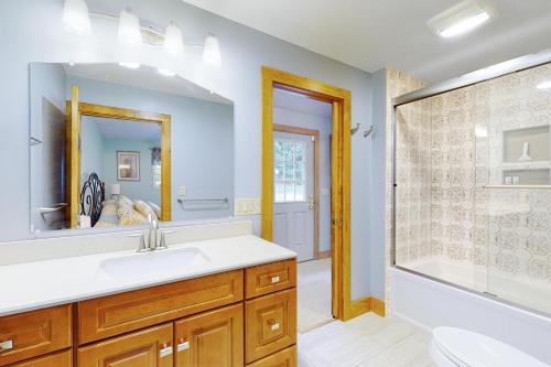 a bathroom with a sink and a tub and a shower at Stoneybrook Retreat Haven - The Carriage House in State Landing