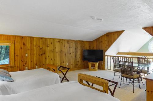 a bedroom with two beds and a flat screen tv at Stoneybrook Retreat Haven - The Carriage House in State Landing