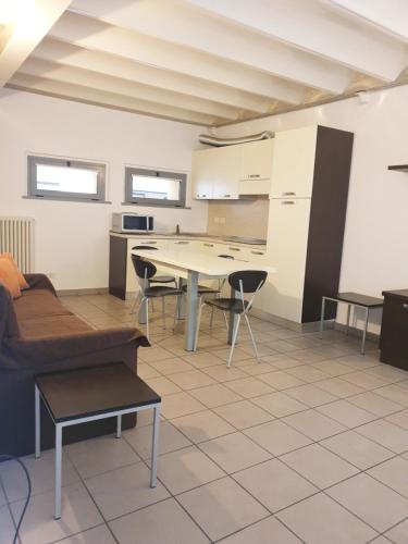 a living room with a couch and a table at Appartamenti tra Lago e Montagna CASA IDEALE LECCO in Lecco