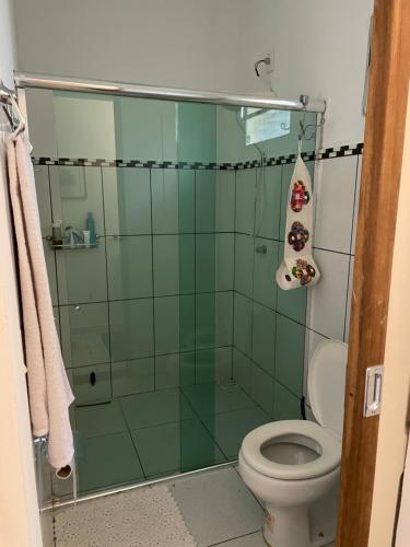 a bathroom with a glass shower with a toilet at Quartos Anavilhanas in Novo Airão