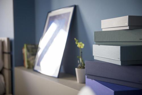a stack of books sitting on a table next to a mirror at Residence Milano Bicocca in Milan