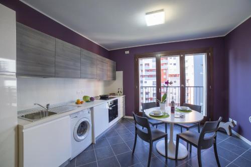 a kitchen with a table and a table and chairs at Residence Milano Bicocca in Milan