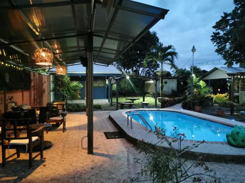 a patio with a swimming pool and an umbrella at Apartamento D Campos in Heredia