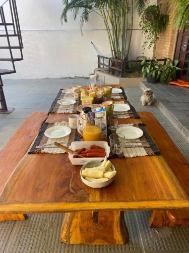 a wooden table with food on top of it at Pousada Querência Maceió in Maceió