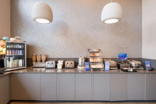 a kitchen with a counter with food on it at Best Western New Oregon Motel in Eugene